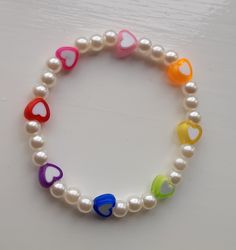 a white bracelet with multicolored hearts and pearls