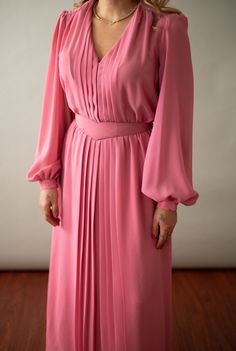 "Elegant pink sheer secretary dress with voluminous poet cuff sleeves with button closures, a mock neck ruffled buttoned collar, tiered accordion skirt & matching belt. Perfect for the summer and fall seasons. Dress is lined and does not have shoulder pads. Back zipper and button closure, elastic waist. In beautiful vintage condition! Belt is included. Fabric Content: 100% Chiffon Polyester ✂----- [m e a s u r e m e n t s] 80's Summer Dress: Fits Small, Medium & Large in depending on desired fit Daywear Dress With Bishop And Blouson Sleeves, Fitted Pink Midi Dress With Elastic Sleeves, Formal Lantern Sleeve Ruffled Dress, Formal Ruffled Lantern Sleeve Dresses, Formal Dresses With Ruffles And Lantern Sleeves, Fitted Dress With Blouson Sleeves For Daywear, Chic Pink Midi Dress With Elastic Sleeves, Daywear Dress With Pleated Bishop Sleeves, Elegant Midi Dress With Ruffles And Bishop Sleeves