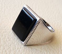 Silver Onyx Signet Ring With Polished Finish, Classic Onyx Ring Jewelry, Classic Onyx Ring, Rectangular Onyx Gemstone Rings, Silver Onyx Gemstone Signet Ring, Rectangular Onyx Signet Ring Gift, Silver Onyx Signet Ring Gift, White Gold Onyx Rings For Gift, Silver Signet Ring With Rectangular Stone For Formal Occasions