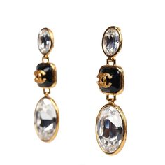 These 21G Chanel crystal earrings are in a drop earrings design, with the classic "Chanel CC" letter logo with black enamel and gold tone hardware. Origin: FranceCondition: New and never wornAccompanied by: Chanel box, ribbon, carebookMeasurements: 2.5" drop Luxury Crystal Dangle Earrings, Luxury Crystal Earrings For Evening, Cc Letter, Classic Chanel, Box Ribbon, Chanel Box, Dangle Earrings Gold, Earrings Design, Crystal Dangle Earrings