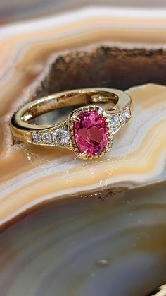 Photo of Padparadscha Sapphire Ring in a decorative scene, designed by , available at Plumb Gold & Plumb Silver Padparadscha Sapphire Ring, Padparadscha Sapphire, 18k Yellow Gold Ring, Yellow Gold Ring, Yellow Gold Rings, Gold Ring, Sapphire Ring, Gold Jewelry, Gold Rings