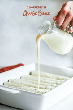 someone pouring cheese sauce into a pan with crackers in it and the words 5 ingredient cheese sauce on top