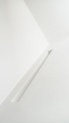 a white wall with an arrow sticking out of it