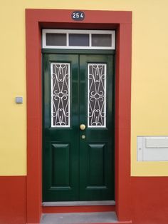 a green door with two glass panels on it