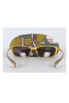 Take these fabulous sunnies everywhere you go! Made with a chic rectangle shaped gold frame with brown gradient lenses. Gold frames Brown gradient lens Made in Italy Rectangle frames Leather trim on arms Comes w/ case & cloth Very light marks on frame Lens width 2.75" Lens height 1.5" Gold Rectangular Tinted Sunglasses, Gold Rectangular Sunglasses With Mirrored Lenses, Gold Rectangular Sunglasses With Tinted Lenses, Retro Gold Sunglasses With Uv Protection, Gold Retro Sunglasses With Uv Protection, Designer Gold Square Frame Sunglasses, Chic Rectangular Sunglasses For Travel, Retro Gold Sunglasses For Beach, Gold Retro Sunglasses With Mirrored Lenses