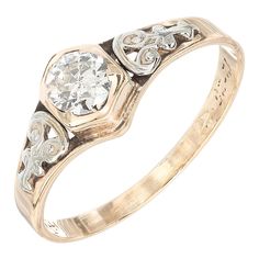 an antique style diamond ring with three stones