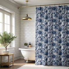 a white bath tub sitting next to a shower curtain