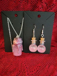 Add a touch of enchantment to your style with this charming Magic Shimmer Potion Bottle Necklace and Earring Set! This whimsical pendant features a miniature glass bottle filled with sparkling shimmer potion, capturing the essence of magic and mystery. The glass bottle is securely sealed and suspended from a dainty chain, perfect for adding a hint of mystical allure to any outfit. Whether you're a lover of fantasy or simply appreciate unique jewelry, this set is sure to bring a touch of magic to your day. Perfect for cosplay or ren faire accesories! ONE OF A KIND PIECE PLEASE NOTE I MAY NOT BE ABLE TO RECREATE THIS SPECIFIC COLOR! (If You Love it.. Get it now!) ;) Each necklace set is a handmade treasure and  truly ONE OF A KIND!  Chains (22.5" long) with easy to use clasps. 925 Sterling S Whimsical Nickel-free Jewelry For Party, Fairy Style Handmade Jewelry For Parties, Fairy Style Dangle Jewelry For Party, Fantasy Dangle Jewelry Gift, Handmade Fairy Style Jewelry For Parties, Handmade Fairy Jewelry For Party, Fairy Potions Aesthetic, Fairycore Jewelry As A Gift, Fairy Style Jewelry With Matching Earrings Gift