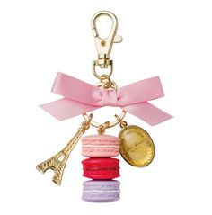 a keychain with a pink ribbon and charms attached to it's side