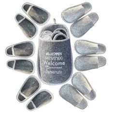 six pairs of slippers with the words welcome to them in white and grey colors