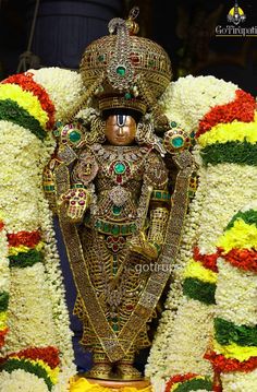 an elaborately decorated statue in gold and green