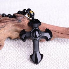 This exquisite hand-carved black obsidian pendant necklace depicts the symbol of the sacred Cross. Material: Natural Black Obsidian, Waxed Cord Chain, Beads Pendant Size: 5.2 x 3.5 cm(2.0" x 1.3") Necklace Length: Adjustable 62 to 78 cm (24.4" - 30.7") Click ADD TO CART To Order Yours Now! The Checkout Process is Guaranteed to be 100% Safe and Secure with Visa, Mastercard, AMex, Discover, Apple Pay or PayPal. Black Obsidian Necklace With 8mm Beads, Black Obsidian Necklace With 108 Beads, Black Amulet Jewelry For Meditation, Black Symbolic Cross Pendant Necklace, Black Agate Spiritual Necklace, Black Agate Necklace With Black Beads, Spiritual Obsidian Black Beads Jewelry, Black Agate Jewelry For Healing, Spiritual Obsidian Jewelry With Black Beads