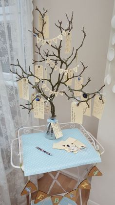 a small table with a tree on it and some cards attached to the top of it