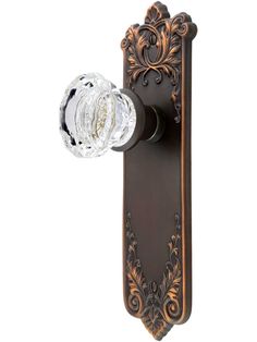 an ornate door handle with a glass knob