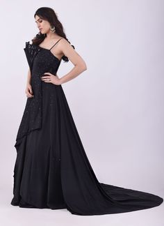 Look simply stunning in this designer black chiffon gown. It is desigend with and fancy layered ruched bodice edged with wires to give it a lovely ruffle design. It is embellished with stone, pearls and sequins work all over. Highlight of the gown is the lovely side trail. Slight variation in color, fabric & work is possible. Pictures shown are for illustration purpose only. NOTE: Originally stitched in size 40 but can be altered for size 38 without any extra cost. Style: Gown Fabric: Chiffon Wo Sequence Blouse, Indo Western Gown, Saree Petticoat, Full Sleeve Blouse, Saree Jewellery, Ready To Wear Saree, Lehenga Skirt, Half Sleeve Blouse, Lehenga Saree