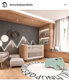 a baby's room is decorated in pink and grey colors with mountains on the wall