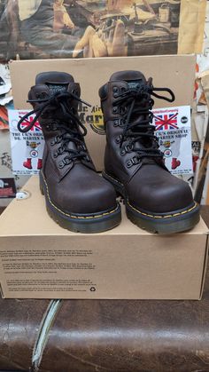 These are a very rare pair of safety rated steel toe Dr Martens boots. The boot itself has 6 speed lace eyelets and comes above the ankle,and have a nice leather padded collar offering extra comfort . The sole unit is the Hud version. They were only used on this and a couple of other boots. Super strong and extremely comfortable. This boot was made in Asia, but to an extremely high standard. They will last those who buy many years. We have UK sizes 3-6 available  European sizes 36-39 USA ladies Brown Shock Resistant Work Boots With Round Toe, Brown Shock Resistant Boots With Round Toe, Brown Lace-up Moto Boots With Steel Toe, Rugged Steel Toe Martin Boots, Rugged Brown Shock-resistant Boots, Rugged Brown Shock Resistant Boots, Rugged Lace-up Martin Boots With Steel Toe, Rugged Steel Toe Lace-up Martin Boots, Rugged Work Boots With Shock Resistant Round Toe