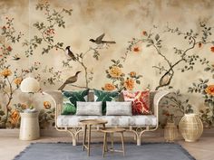 a living room with floral wallpaper and birds on the tree branch, in front of a couch