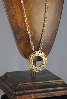 "FABULOUS Donut Vintage Pendant. It is gold toned and from the 1960s. Never before worn. In excellent vintage condition. Beautiful filigree work within the pendant! This pendant has two pieces, as you can see in the last photo! For those of you who are handy, you could actually turn them into hoop earrings! (Just a vintage repurposed idea Hangs from a fabulous 22\" vintage chain. The pendant measures 1 7/8\" in diameter. Perfect addition to your vintage collection!" Vintage Gold Plated Medallion Jewelry, Gold Brass Medallion Necklace With Gold Chain, Vintage Gold Plated Medallion Necklace Gift, Vintage Gold Plated Medallion Necklace For Gift, Vintage Gold Plated Medallion Necklace As Gift, Vintage Gold-tone Medallion Necklace, Vintage Yellow Gold Plated Medallion Necklace, Gold Filigree Costume Jewelry Necklace, Vintage Gold-tone Round Pendant Jewelry