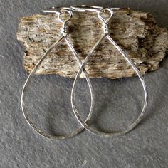 A thicker gauge sterling silver (18 gauge) is formed into tear drops, hammered for texture and then tumbled in steel shot for a brilliant shine. Ear wires are hand formed from sterling silver. Earrings measure approximately 2.25 inches from top of ear wire to bottom of tear drop. These earrings are eco friendly as the silver comes from a recycled source. The last photo shows all the different sizes together. For extra small sterling silver teardrops see-------> https://www.etsy.com/listing/48 Metal Long Drop Hoop Earrings As Gift, Everyday Metal Drop Hoop Earrings, Metal Hoop Earrings For Gift, Nickel-free Long Drop Hoop Earrings Gift, Everyday Long Drop Hoop Earrings With Ear Wire, Metal Drop Hoop Earrings With Ear Wire, Metal Teardrop Earrings With Lever Back, Nickel-free Metal Drop Hoop Earrings, Handmade Sterling Silver Drop Hoop Earrings