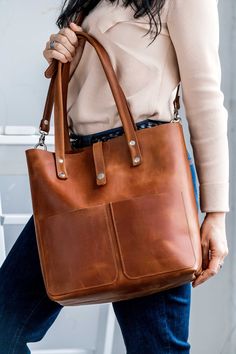 ● Comfortable and popular leather tote bag. It is made of full grain leather cognac color. Great for daily use. Ideal for work, study. The bag has pockets, so it is very roomy and functional (for a phone, book, keys, tablet, Mac, cosmetic bag, etc.). This bag can be a wonderful gift for a birthday, Christmas and New year gift. Handmade leather bag! ● ● Unique leather over time gets better. A bag can be made in different leather colors: cognac, chocolate, black, caramel, olive, yellow, burgundy, Everyday Brown Weekender Bag With Smooth Grain, Cognac Weekender Bag With Smooth Grain, Cognac Satchel Weekender Bag For Everyday, Cognac Smooth Grain Weekender Bag, Cognac Tote Weekender Bag, Cognac Leather-lined Tote Weekender Bag, Cognac Soft Leather Weekender Bag, Brandy Leather Bag For Everyday Use, Cognac Leather Bag