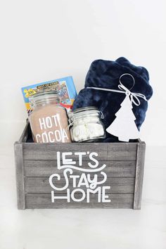 a wooden crate filled with various items and the words, let's stay home