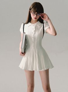 Channel a charming scholarly look with our Vintage Scholar Pleated Mini Dress. This delightful white dress combines classic elements with a modern mini length, perfect for a variety of occasions. Product Details: Color: White Style: Vintage-inspired mini dress Features: Pleated skirt, collar detail, short sleeves Available Sizes: XS, S, M Size Chart (measurements in cm): Size Length Bust Sleeve length Waist XS 73 84 15 64 S 73 88 15 68 M 75 92 16 72 Model Information: Height: 165cm Weight: 50kg Wearing Size: S Styling Tips: This versatile dress can be styled for both casual and semi-formal occasions. Pair with loafers and ankle socks for a true scholarly look, or dress it up with heels and delicate jewelry for a night out. Add a cardigan or blazer for cooler weather. The pleated skirt and Elegant White Pleated Mini Dress, Preppy Fitted Mini Dress, Summer Mini Dress For The Office, Summer Mini Dress For Office, Chic Fitted Mini Dress With Doll Collar, Preppy Fitted Knee-length Dresses, Elegant Fitted Mini Dress With Doll Collar, Elegant White Mini Dress With Doll Collar, Fitted Preppy Mini Dress For Summer