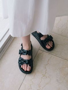 Editor's NotesThese classy sandals are perfect to dress up or down on a summer day or night- Bow detailed velcro strap sandals- Buckle detailed- Modern round toe - Molded insole for extra comfort- Romantic and lovely look for all summerMeasurements(in.)- Size: KR225mm- KR255mm (US 5.5 - US 8.5) - Heel Height: 1.6 inComposition & Care- Recycled Cow skin- Keep away from direct sunlight and moisture- Store in a dust bag or in a cool and dark area when not using - Avoid wearing in Summer Jelly Sandals With Adjustable Strap And Round Toe, Black Open Toe Slingback Sandals With Strap, Summer Sport Sandals With Strap And Round Toe, Summer Sport Sandals With Round Toe And Strap, Summer Footbed Sandals With Strap And Round Toe, Summer Footbed Sandals With Round Toe And Strap, Chic Jelly Sandals With Buckle Closure And Round Toe, Summer Closed Toe Sport Sandals With Heel Loop, Closed Toe Sport Sandals With Heel Loop For Summer