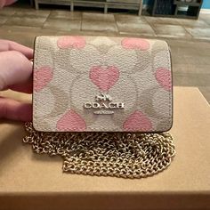 Brand New With The Tags And Absolutely Gorgeous Describes This Authentic Coach Mini Wallet On A Chain In Signature Canvas With Heart Print. Color: Gold/Light Khaki Chalk Multi Signature Coated Canvas And Smooth Leather Two Credit Card Slots Snap Closure, Fabric Lining Outside Open Pocket Detachable Chain Strap With 23 1/4" Drop For Crossbody Wear Measures: 4" (L) X 3" (H) X 1" (W) Coach Mini Wallet On A Chain, Mini Wallet Coach, Coach Wallet On Chain, Coach Mini Wallet, Pink Coach Wallet, Coach Pink Wallets For Travel, Cute Wallets, Signature Canvas