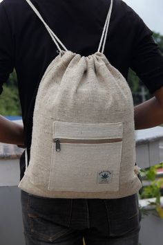 This Hemp Drawstring Bag from Handicrafts In Nepal (HIN) is available with a minimalist shoulder strap that can easily open the main space and one small zipper pocket on the outer side. It can be used for hiking which helps to carry light items such as a book, phone, and other gears. Not only that, but you can also use it while going to the beach and carnivals.   The mixture of Hemp and Cotton are the materials for this drawstring backpack. Hemp is naturally grown in Nepal and considered one of Eco-friendly Adjustable Bag For Daily Use, Handmade Casual Outdoor Bags, Casual Handmade Outdoor Bag, Casual Handmade Bags For Outdoor, Casual Natural Backpack For Everyday Use, Minimalist Backpacking, Rains Backpack, Backpacking Essentials, Cloth Accessories