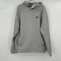 This Nike Men's Tech Fleece Pullover Hoodie Sweatshirt In Size L And Gray/Black Color Is Perfect For Any Sports Enthusiast. The Hoodie Features A Solid Pattern, Crew Neck, Long Sleeve, And Is Made Of A Combination Of Polyester, Cotton, And Cotton Blend Material. It Also Has Fleece Fabric Type, Lined, Hooded, And Pockets Making It Ideal For Any Season, Winter, Summer, Fall, Or Spring. The Nike Tech Hoodie In Gray And Black Color Comes With The Logo Embossed On It, Making It Perfect For Any Sports Sports Hoodie Sweater, Sportswear Sweatshirt With Ribbed Cuffs For Outdoor, Gray Fleece Sweater For Streetwear, Outdoor Sportswear Sweatshirt With Ribbed Cuffs, Light Sports Hoodie Sweatshirt With Ribbed Cuffs, Nike Urban Fleece Sweatshirt, Hoodie Sweatshirt With Ribbed Cuffs For Light Sports, Athletic Heather Hoodie For Winter Sportswear, Grey Hoodie For Winter Sportswear