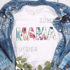 a t - shirt with the word mama printed on it next to a plant and denim jacket