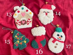 crocheted christmas ornaments are displayed on a red cloth with numbers in the middle