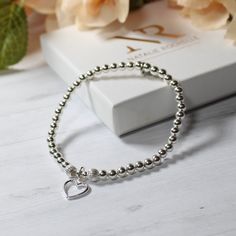 Sterling Silver Beaded Stacking Bracelet with Hollow Heart Charm Perfect gift for her/Ladies bracelet/bridal jewellery/Bridesmaid gift This beautiful bracelet is: handmade with 4mm Sterling silver round beads and two 5mm sterling silver corrugated beads and added hollow heart charm. Bracelets are made using durable jewellery elastic to an approximate length of 19cm. Should you require a bespoke size, please don't hesitate to contact me, Your jewellery comes packaged in a Natalie Rochelle gift box. Heart-shaped Silver Beaded Bracelets For Gifts, Heart Shaped Silver Beaded Bracelet For Gift, Heart-shaped Silver Beaded Bracelet For Gift, Heart-shaped Silver Beaded Bracelet Gift, Silver Heart-shaped Dainty Beaded Bracelets, Elegant Silver Beaded Bracelets With Heart Charm, Dainty Silver Heart Beaded Bracelets, Dainty Silver Heart-shaped Beaded Bracelets, Elegant Silver Beaded Bracelet With Heart Charm