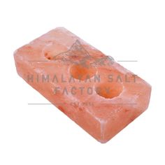 an orange piece of rock with the words himalayan salt factory on it's side