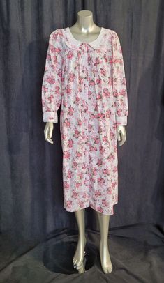 Indulge in vintage charm with this Cypress pink floral cotton gown/robe. The women's size S gown features a comfortable fit for regular size types and is made of soft cotton material that feels gentle on the skin.  The pink floral design adds a touch of elegance to the gown/robe, making it ideal for vintage lingerie enthusiasts. This vintage piece is a must-have for anyone who loves unique clothing, and it's ready to become a part of your vintage collection. New without tags.  Measured lying fla Pink Floral Print Nightgown For Home, Pink Cotton Sleepwear With Floral Print, Pink Vintage Floral Print Sleepwear, Vintage Cotton Long Sleeve Nightgown, Vintage Long Sleeve Cotton Nightgown, Pink Floral Print Cotton Nightgown, Cotton Gowns, Womens Pajamas, Pink Floral Design