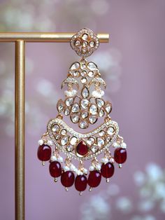 Embrace timeless elegance with our Chashni Chandbali kundan earrings: a masterpiece of traditional craftsmanship and contemporary allure. A stunning piece of unique South Asian jewelry, Chashni is an elegant 21K gold plated chandelier earring adorned with a shimmering Alhambra motif, dangling mini crescents, and lustrous pearls. Chashni's kundan stones are meticulously hand-set by master artisans to create an ethereal array of light that dazzles in every environment. Enhance even your most elegant outfit with the intricate and breathtaking Chashni Chandbali statement earrings.  Materials: 21K gold plating on brass, kundan stones, gemstone beads, pearls Dimensions (L x W): 3.5 x 2.25 inches Weight: 24g (per chandbali) Festive Yellow Gold Bollywood Danglers, Temple Style Chandbalis With Stone Work For Reception, Festive Fusion Kundan Jhumkas, Traditional Yellow Gold Kundan Danglers, Bollywood Earrings With Intricate Design For Reception, Festive Heavy 22k Gold Chandbalis, Bollywood Style Earrings With Intricate Design For Reception, Festive 22k Gold Chandbali Danglers, Bollywood Yellow Gold Danglers For Festive Occasions