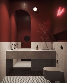 a bathroom with red walls and black and white flooring