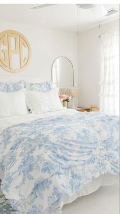 a bed with blue and white comforter in a bedroom