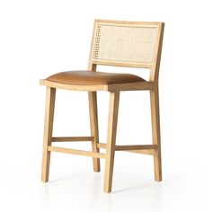 a wooden stool with a leather seat and backrest on an isolated white background photo