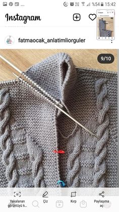 an image of someones knitted sweater with knitting needles in the middle and on top