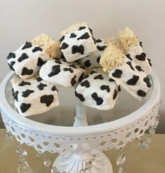 a cake plate with cookies and marshmallows on it