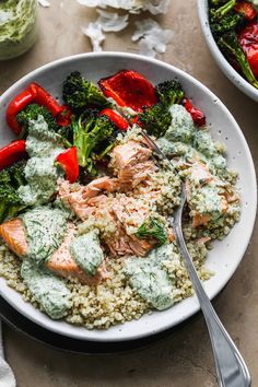 healthy salmon quinoa bowl with broccoli and red peppers on the side