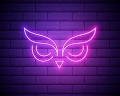 an owl neon sign on a brick wall