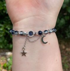 This Starry Sky bracelet features silver star and moon charms on stainless steel chain. The starry night vibes are sure to evoke a sense of wonder and magic. Beautiful blue to white gradiant glass beads lace the elastic band that has a hidden knot secured with jewelers glue for extra strength. It fits up to 8in wrists. Starry Night Bracelet, Midnight Rain Bracelet, Midnight Jewelry, Hidden Knot, Astronomy Jewelry, Bracelet Inspo, Moon Bracelet, The Starry Night, Charm Collection