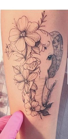 an elephant with flowers on it's back thigh and behind its head is a pink glove