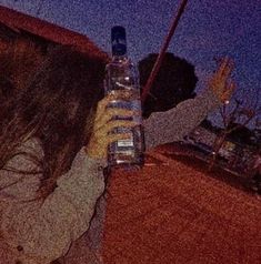 a woman holding up a bottle of water