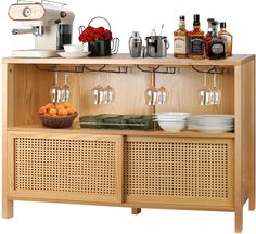 a wooden cabinet with wine glasses and bowls on the top, next to an espresso machine