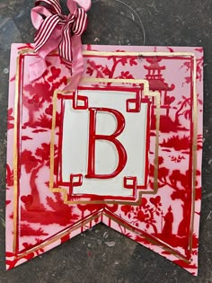 the letter b is cut out from paper and placed on top of a piece of fabric