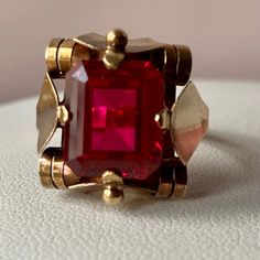 Breathtaking Vintage Retro Ring ! Huge Synthetic Cherry Red Ruby Stone ,Simply Superb !!! Done In Solid 14k Yellow Gold (Partially Visible European Stamp Of 585 And Also Tested) , Weights 6.60 Grams , Size 9 On Ring Mandrel (Probably Sizable By A Skilled Jeweler ) .The Stone Is Approx. 12x10mm In Size, Condition Is Excellent , No Eye Visible Scratches Or Damage To The Stone Of Any Kind, Gold Shows Normal Signs Of Wear. Simply Beautiful, One Of A Kind Retro Statement Ring Of European Origin Classic Red Ruby Jewelry, 14k Gold Red Ruby Ring Fine Jewelry, Elegant Faceted Ruby Ring For Formal Occasions, Elegant Formal Faceted Ruby Ring, Elegant Red 14k Gold Jewelry, Classic Red Ruby Ring With Vs Clarity, Formal Ruby Jewelry With Faceted Details, Elegant Faceted Ruby Ring In Yellow Gold, Elegant Yellow Gold Faceted Ruby Ring